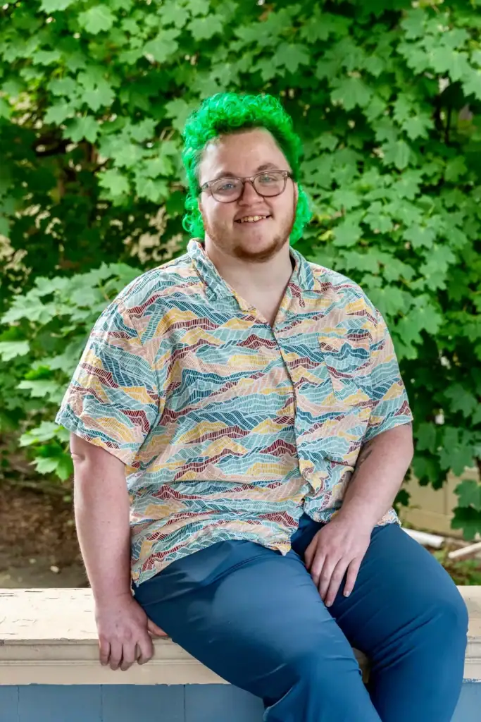 Olivia Therrien smiling outdoors at Confluence Behavioral Health.