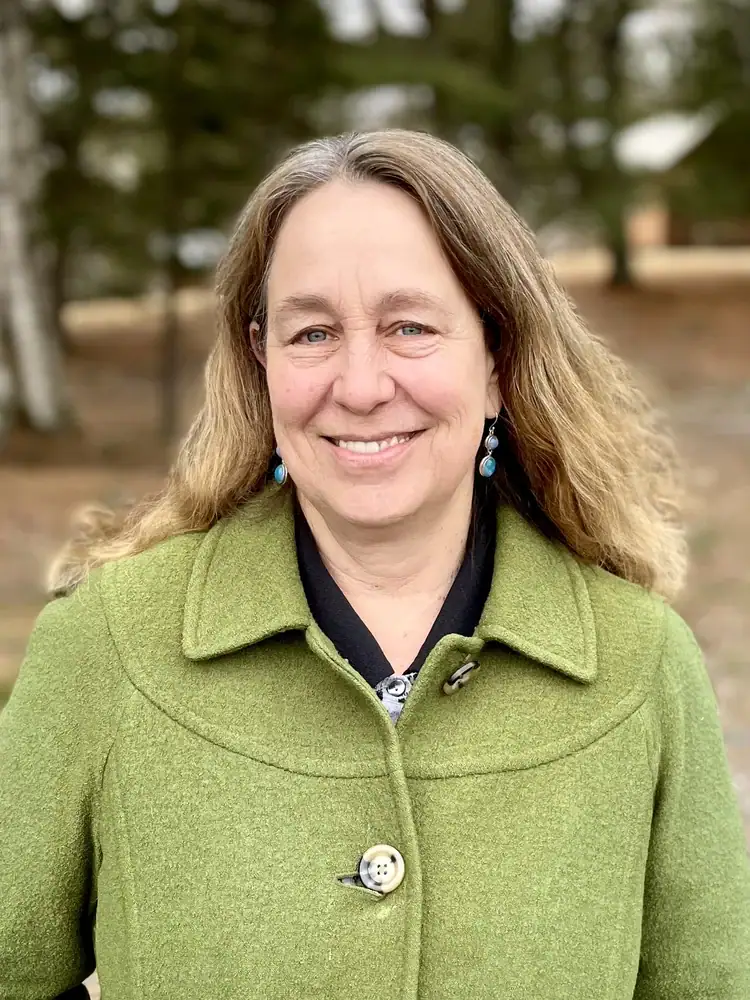 RN Lisa Willems at Confluence Behavioral Health smiling outdoors.