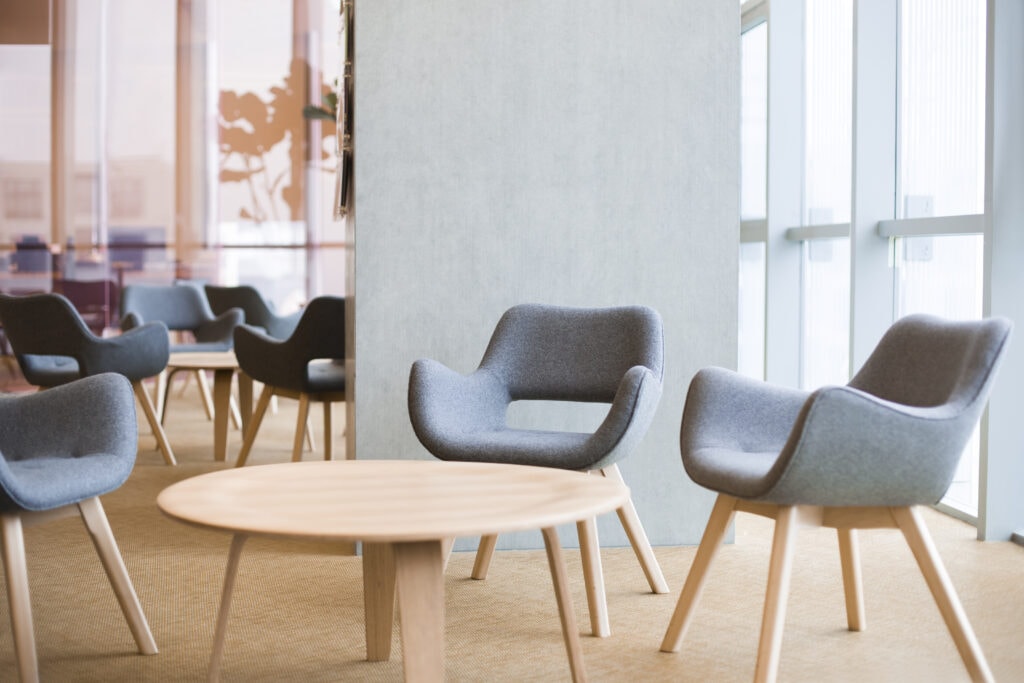 Modern waiting room with cozy chairs and round table at Confluence Behavioral Health.