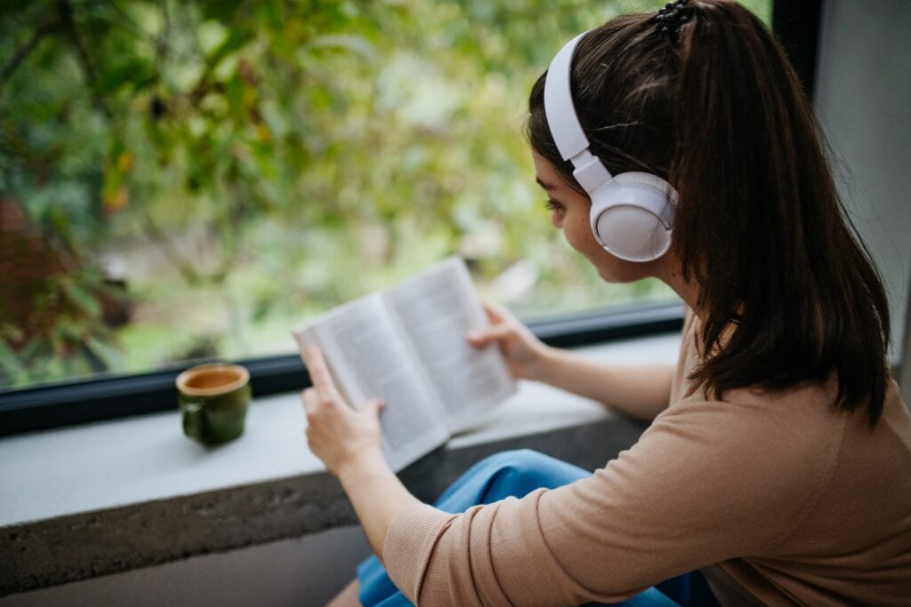 Young woman reading mental health books for young adults.