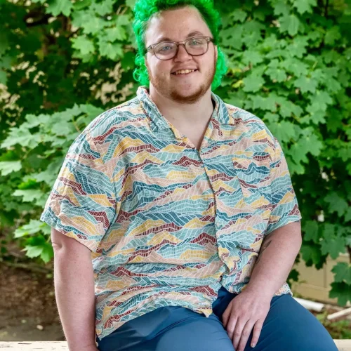 Olivia Therrien smiling outdoors at Confluence Behavioral Health.