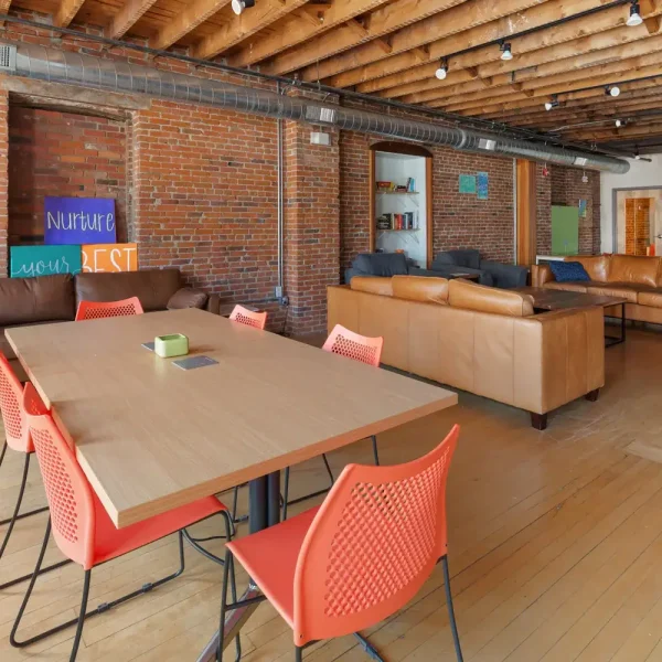 Cozy transitional living space with seating and communal area for recovery.