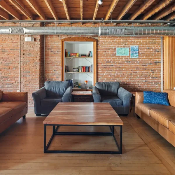 Relaxing transitional living space with leather sofas and a wooden coffee table.