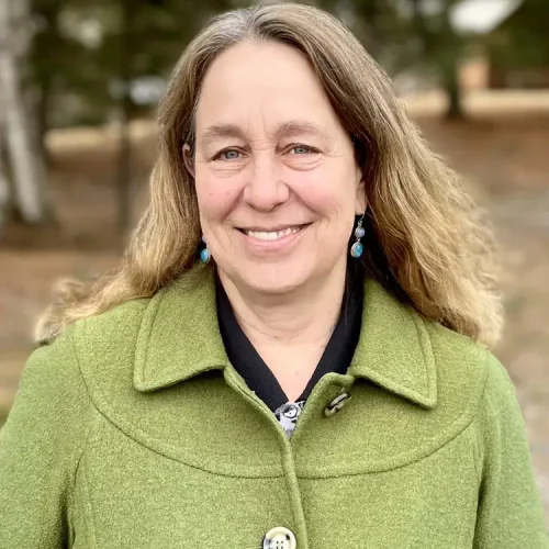 RN Lisa Willems at Confluence Behavioral Health smiling outdoors.